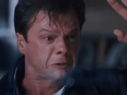 A Close Up Of A Man 'S Face With A Blurry Background . GIF