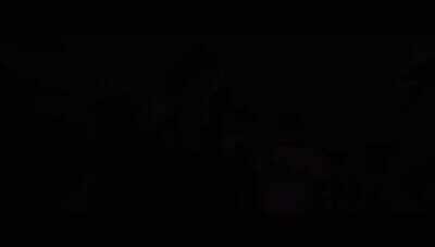 A Close Up Of A Man 'S Face With A Blurry Background Behind Him GIF