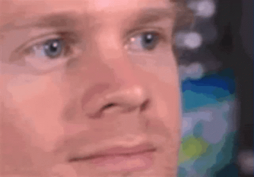 A Close Up Of A Man 'S Face With A Blurry Background . GIF