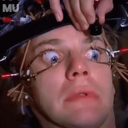 A Close Up Of A Man 'S Face With A Bottle In His Eye GIF