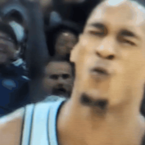 A Close Up Of A Man 'S Face With A Bow On His Neck GIF