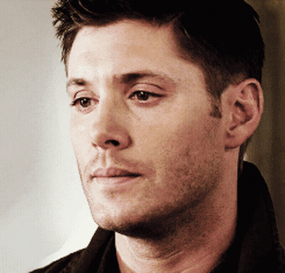 A Close Up Of A Man 'S Face With A Brown Shirt On GIF