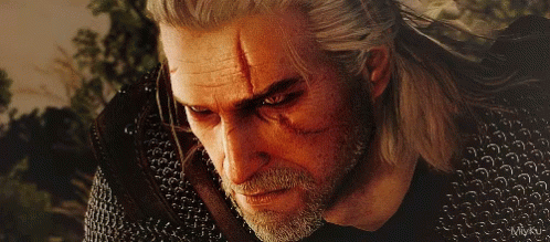A Close Up Of A Man 'S Face With A Chain Mail Jacket GIF