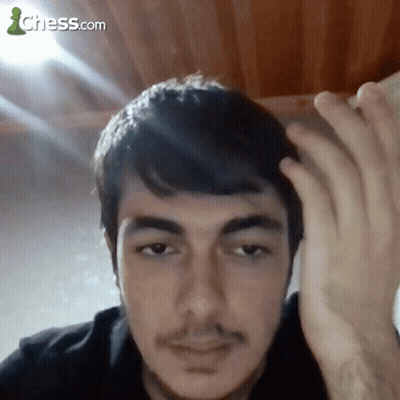 A Close Up Of A Man 'S Face With A Chess.com Logo In The Background GIF