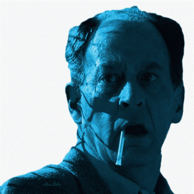 A Close Up Of A Man 'S Face With A Cigarette In His Mouth And A Watermark That Says Alex Bello GIF