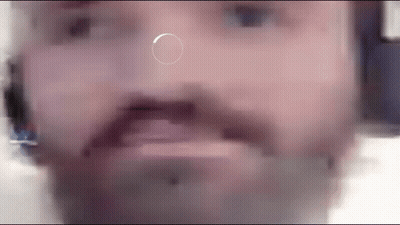 A Close Up Of A Man 'S Face With A Circle In The Middle Of His Nose . GIF