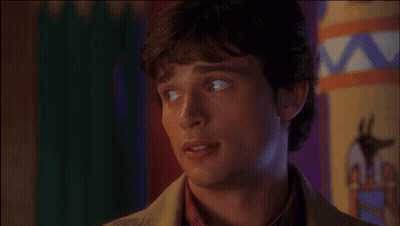 A Close Up Of A Man 'S Face With A Colorful Background Behind Him GIF