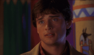 A Close Up Of A Man 'S Face With A Colorful Background In The Background GIF