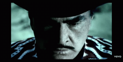 A Close Up Of A Man 'S Face With A Cowboy Hat And A Mustache . GIF