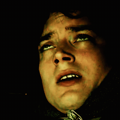 A Close Up Of A Man 'S Face With A Cross On It GIF