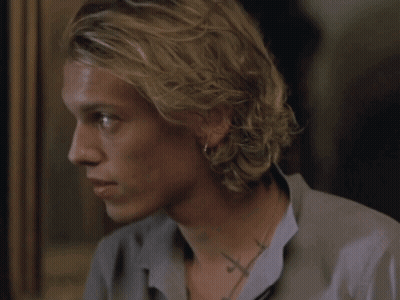 A Close Up Of A Man 'S Face With A Cross Tattoo On His Neck GIF