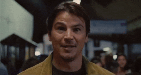 A Close Up Of A Man 'S Face With A Crowd In The Background GIF