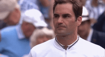 A Close Up Of A Man 'S Face With A Crowd In The Background GIF