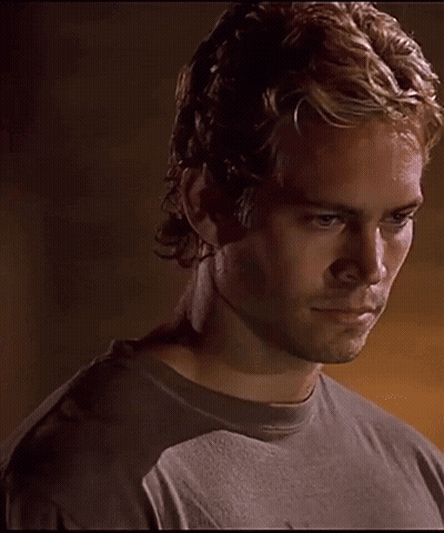 A Close Up Of A Man 'S Face With A Dark Background GIF
