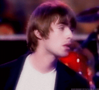 A Close Up Of A Man 'S Face With A Drum In The Background GIF