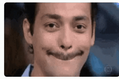 A Close Up Of A Man 'S Face With A Fake Smile On It . GIF