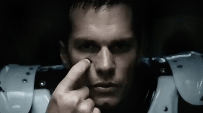 A Close Up Of A Man 'S Face With A Finger On His Nose . GIF