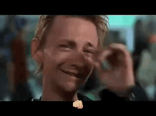 A Close Up Of A Man 'S Face With A Fist In The Foreground GIF