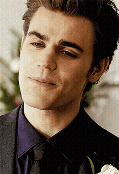 A Close Up Of A Man 'S Face With A Flower In The Foreground GIF
