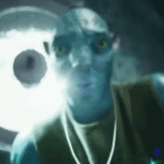 A Close Up Of A Man 'S Face With A Glowing Light Behind Him GIF