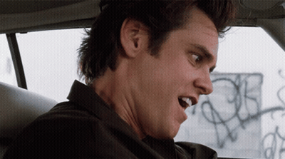 A Close Up Of A Man 'S Face With A Graffiti Wall In The Background GIF