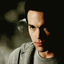 A Close Up Of A Man 'S Face With A Gray Shirt On GIF