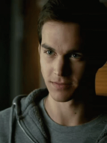 A Close Up Of A Man 'S Face With A Gray Shirt On GIF