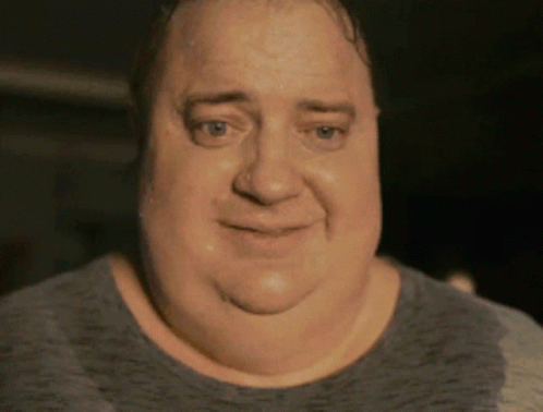 A Close Up Of A Man 'S Face With A Gray Shirt GIF