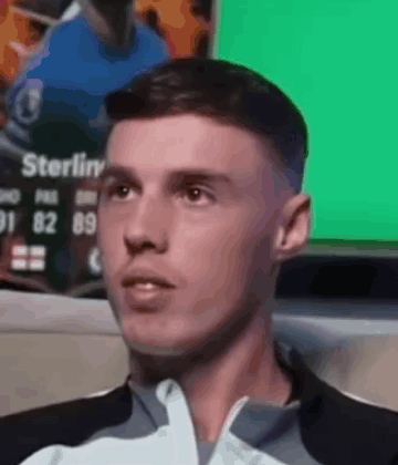 A Close Up Of A Man 'S Face With A Green Background GIF