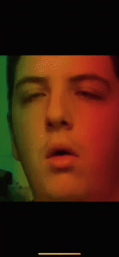A Close Up Of A Man 'S Face With A Green Background GIF