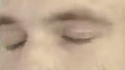 A Close Up Of A Man 'S Face With A Green Circle Around His Head GIF