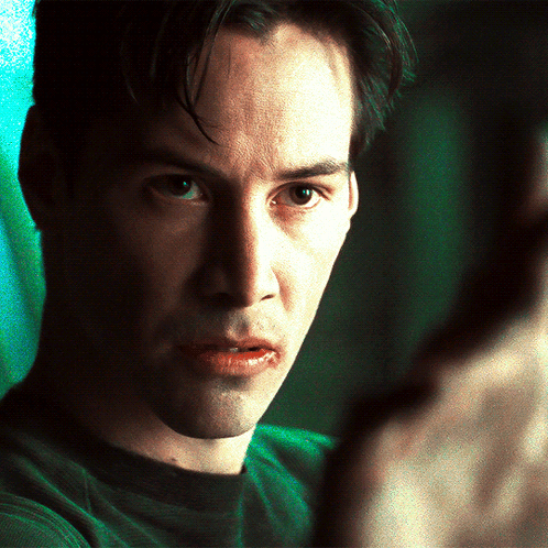 A Close Up Of A Man 'S Face With A Green Shirt GIF