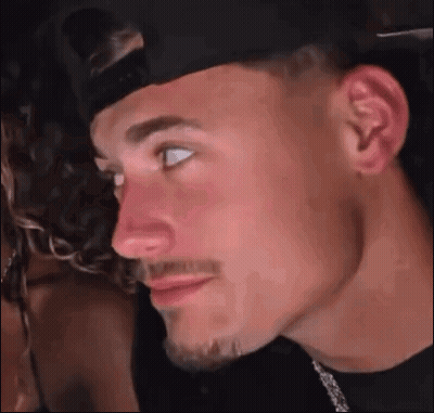 A Close Up Of A Man 'S Face With A Hat On And A Beard . GIF