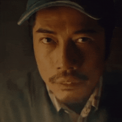 A Close Up Of A Man 'S Face With A Hat On And A Mustache . GIF