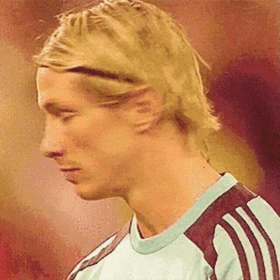 A Close Up Of A Man 'S Face With A Headband On His Head . GIF