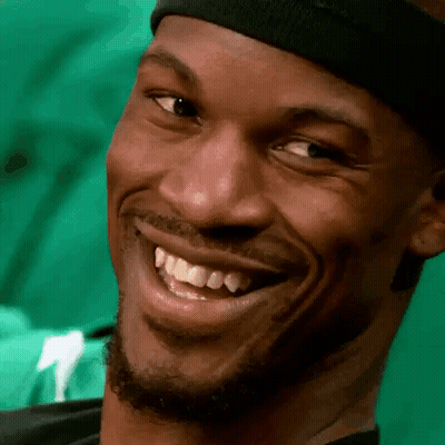 A Close Up Of A Man 'S Face With A Headband On Smiling . GIF