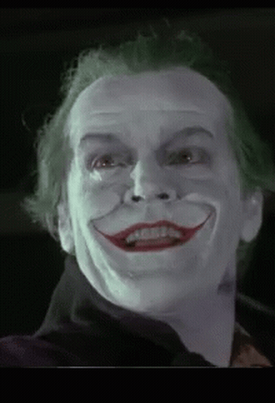 A Close Up Of A Man 'S Face With A Joker 'S Face Painted On It . GIF