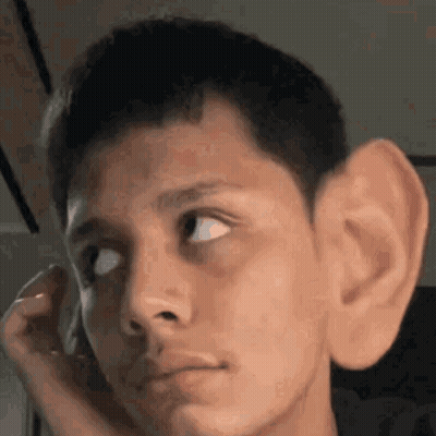 A Close Up Of A Man 'S Face With A Large Ear . GIF