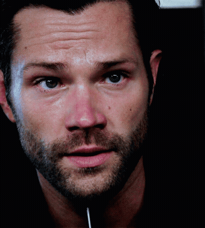 A Close Up Of A Man 'S Face With A Lollipop Sticking Out Of His Mouth GIF