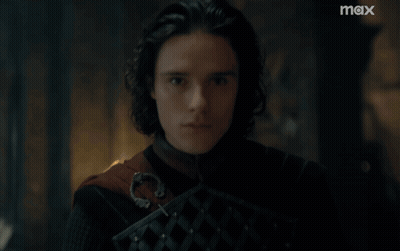 A Close Up Of A Man 'S Face With A Max Logo In The Background GIF