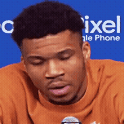 A Close Up Of A Man 'S Face With A Microphone In Front Of Him . GIF
