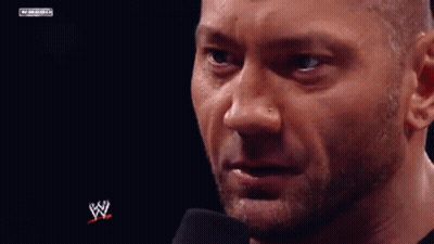 A Close Up Of A Man 'S Face With A Microphone In Front Of Him And A W Logo In The Background . GIF