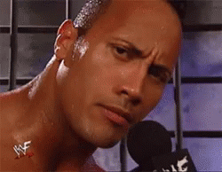 A Close Up Of A Man 'S Face With A Microphone In Front Of Him . GIF