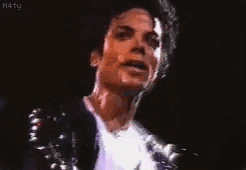 A Close Up Of A Man 'S Face With A Microphone In The Background . GIF