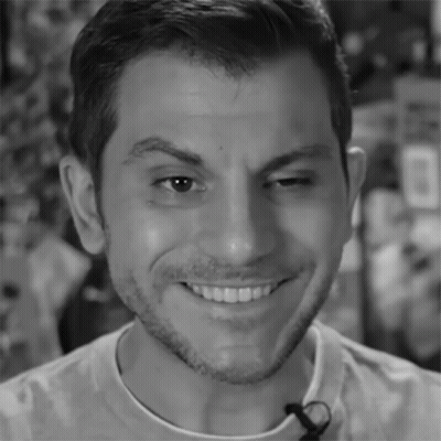 A Close Up Of A Man 'S Face With A Microphone On His Neck GIF