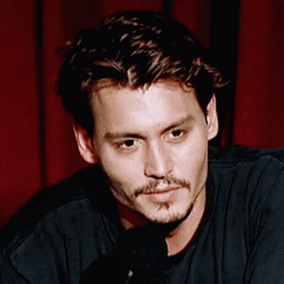 A Close Up Of A Man 'S Face With A Microphone GIF