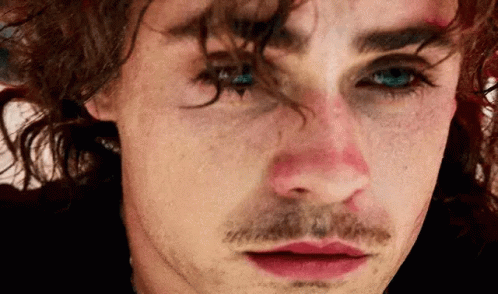 A Close Up Of A Man 'S Face With A Mustache And A Red Nose . GIF