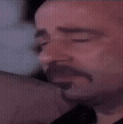 A Close Up Of A Man 'S Face With A Mustache And Beard . GIF