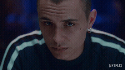 A Close Up Of A Man 'S Face With A Netflix Logo In The Background GIF