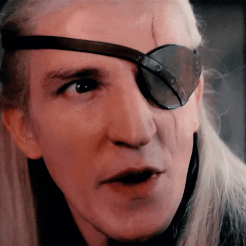 A Close Up Of A Man 'S Face With A Patch On His Eye GIF